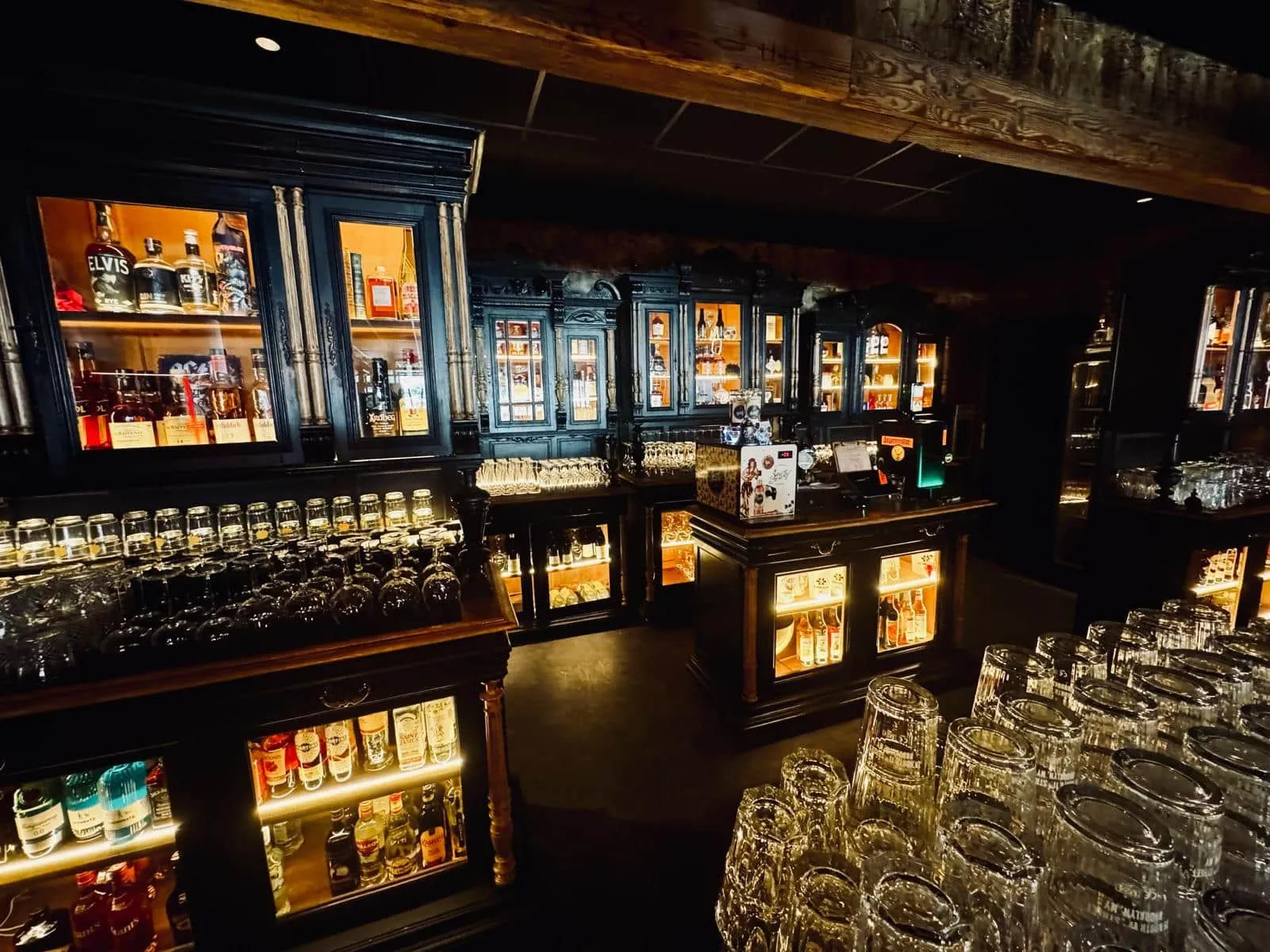 Le comptoir du Saint Rock Bar et ses vitrines de bouteilles éclairées